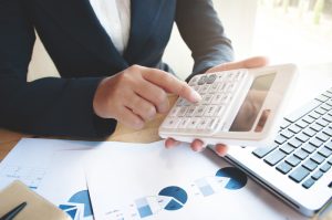 Business Audit Woman Using Calculator