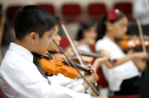 Children Playing Violins in an orchestra