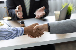 Business people shaking hands after mediation