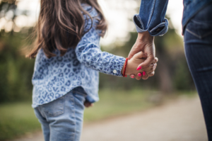 Childing holding parent's hand