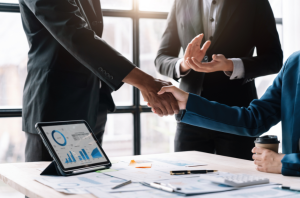 Businessmen shaking hands after closing mergers and acquisitions deal