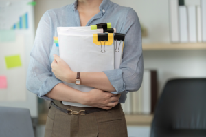 Business woman holding organizational files for merger and acquisitions due diligence