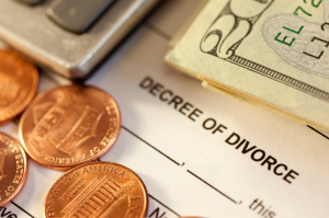 Calculator and financial documents illustrating the cost of a Texas divorce