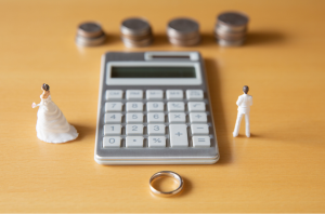 Calculator and financial documents illustrating the cost of a Texas divorce