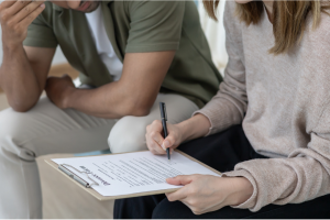 Couple signing uncontested Texas divorce agreement with an Austin family lawyer